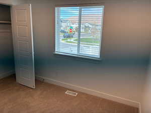 Unfurnished bedroom with carpet floors and a closet