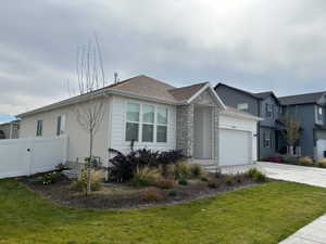 View of home's exterior featuring concrete driveway, stone siding, and an attached garage