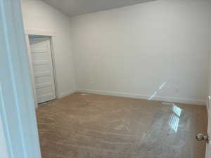 Carpeted empty room with baseboards
