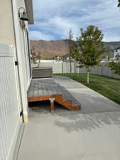 Fenced backyard featuring a deck with mountain view