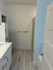 Full bathroom featuring vanity, light wood finished floors, a shower stall, and a bath