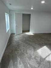 Unfurnished bedroom with carpet, a textured ceiling, and a closet