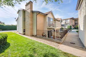 Rear view of house featuring brick siding and a chimney