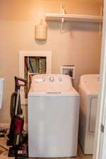 Laundry room featuring separate washer and dryer and tile patterned floors