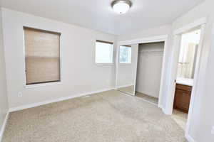 Second bedroom featuring light colored carpet and a large closet
