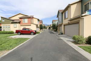 View of the street in the rear of the townhome with garage access.