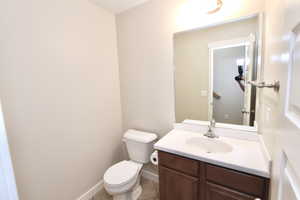 Half bathroom featuring vanity and tile floors
