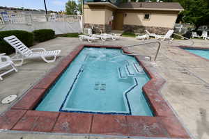 Community pool with a patio