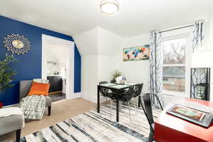 Office area with lofted ceiling, carpet floors, and a textured ceiling