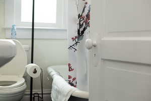 Detailed view of a shower with shower curtain and a bathtub