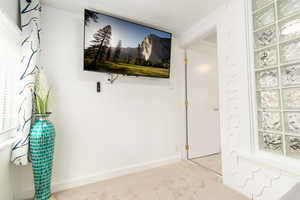 Interior space featuring carpet floors and baseboards