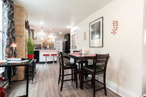 Dining room featuring wood finished floors and recessed lighting