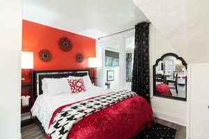Bedroom featuring wood finished floors and a textured ceiling