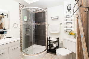 Bathroom with a stall shower, vanity, and tile patterned floors