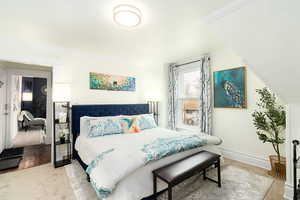 Bedroom featuring crown molding and carpet