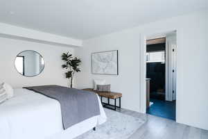 Bedroom featuring wood finished floors and baseboards
