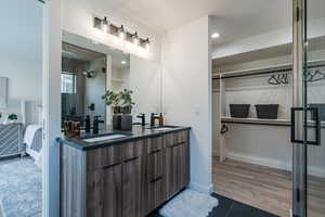 Bathroom with ensuite bathroom, double vanity, tile patterned floors, recessed lighting, and a shower