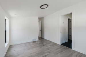 Empty room featuring light wood-style flooring and baseboards