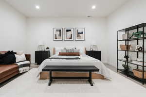 Carpeted bedroom with recessed lighting