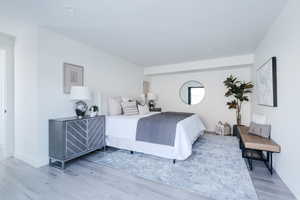 Bedroom featuring baseboards and wood finished floors