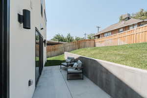 Fenced backyard featuring a patio