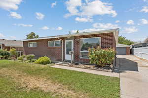 Ranch/Rambler-style house featuring brick siding, an outbuilding, and a detached garage