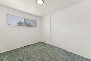 Unfurnished bedroom featuring carpet flooring and a closet