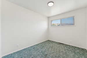 Bedroom with carpet and window