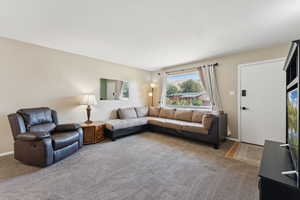 Living area with carpet floors and baseboards