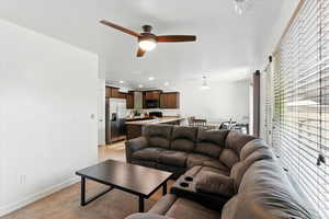Living room with ceiling fan, recessed lighting, and light carpet