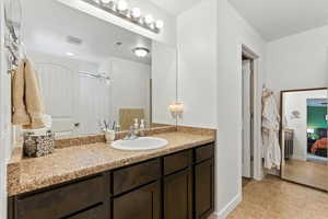 Full bath with vanity, ensuite bath, tile patterned flooring, and curtained shower