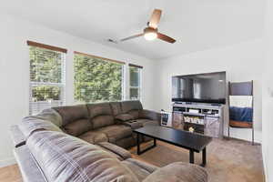 Living room with baseboards and ceiling fan