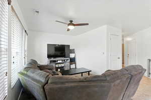 Living room featuring ceiling fan and light tile patterned floors