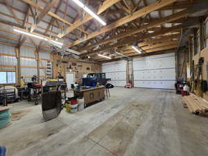 Garage with a workshop area and metal wall