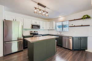 Updated kitchen w/new granite counters, gourmet butcher block island, subway tile backsplash, farmhouse sink & water filteration