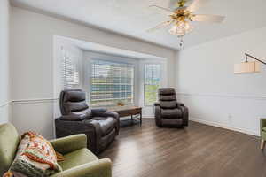 Living room featuring wood laminate floors and bay window