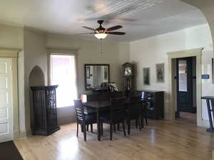 Dining area with solid maple flooring, ornamental molding, arches, cubbys and recesses.