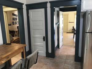 Corridor with light tile patterned flooring