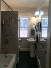 Full bathroom featuring tile patterned flooring and bathtub / shower combination