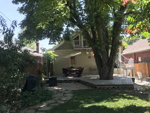 Back of house with a patio, a deck, and outside stairs,