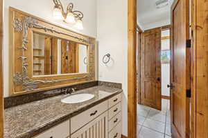 Bathroom with vanity and tile patterned floors