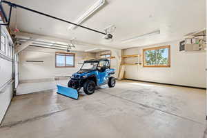 Garage with a heating unit and baseboards