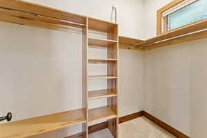 Spacious closet with carpet floors