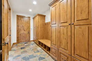 Mudroom featuring stone finish floors and recessed lighting