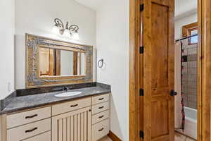 Bathroom featuring vanity and shower / tub combo