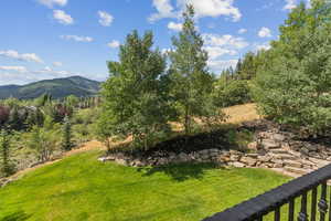 View of green lawn featuring a mountain view
