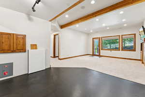 Carpeted spare room with beamed ceiling and recessed lighting