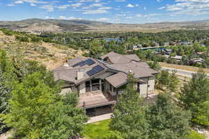 Drone / aerial view of a water and mountain view and a tree filled landscape