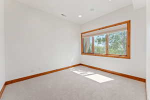 Spare room featuring carpet flooring and recessed lighting