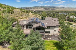 Aerial view of property and surrounding area featuring a mountain backdrop